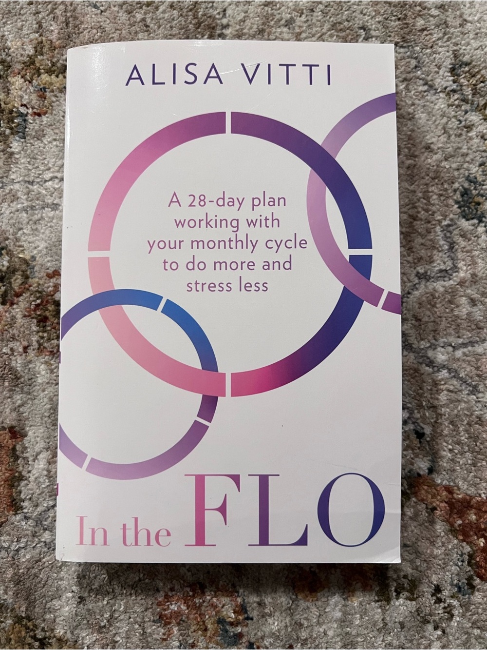 In the FLO by Alisa Vitti - White Book with Pink & Purple Rings